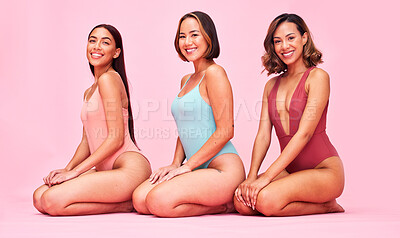 Buy stock photo Diversity, bikini and portrait of happy women in studio, sitting together with smile and fun body positivity. Beauty, summer fashion and swimwear models with self love, equality and pink background.