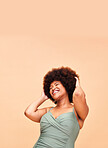 Black woman, swimwear and self love, smile and confident with body positivity in studio on peach background mockup space. Happy, person and girl in natural beauty and face for freedom in swimsuit