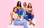 Fashion model, stairs and portrait of women in studio for clothing promotion, discount and retail sale. Friends, beauty and people on pink background in denim outfit, trendy clothes and casual style