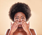 Black woman, hands on face and beauty in studio for skin care, dermatology and natural glow. Portrait of a happy African model person with afro hair, cosmetics and self love on a beige background