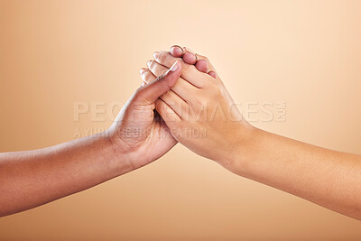 Buy stock photo Beauty, skincare and support with women holding hands in studio on a beige background for community or motivation. Trust, natural and cosmetics with model friends connected in unity or solidarity