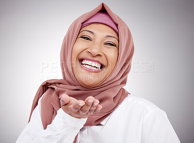 Buy stock photo Muslim woman, portrait and blowing a kiss in studio with happiness, kindness or positive attitude. Hijab, islam and fashion of a mature person on grey background for beauty, cosmetics or flirting