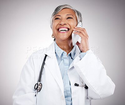 Buy stock photo Phone call, doctor and woman in studio for happy conversation, medical consulting or telehealth contact. Mature surgeon, laugh or talk on mobile in communication, support or advice on gray background