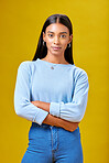 Arms crossed, fashion and student with portrait of woman in studio for future, pride and  serious. Youth, confident and college with Indian person on yellow background for learning and trendy style