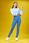 Pointing, advertising and portrait of a woman in a studio for creative, marketing or promotion. Smile, happy and full length of Indian female model with a direction hand gesture by yellow background.