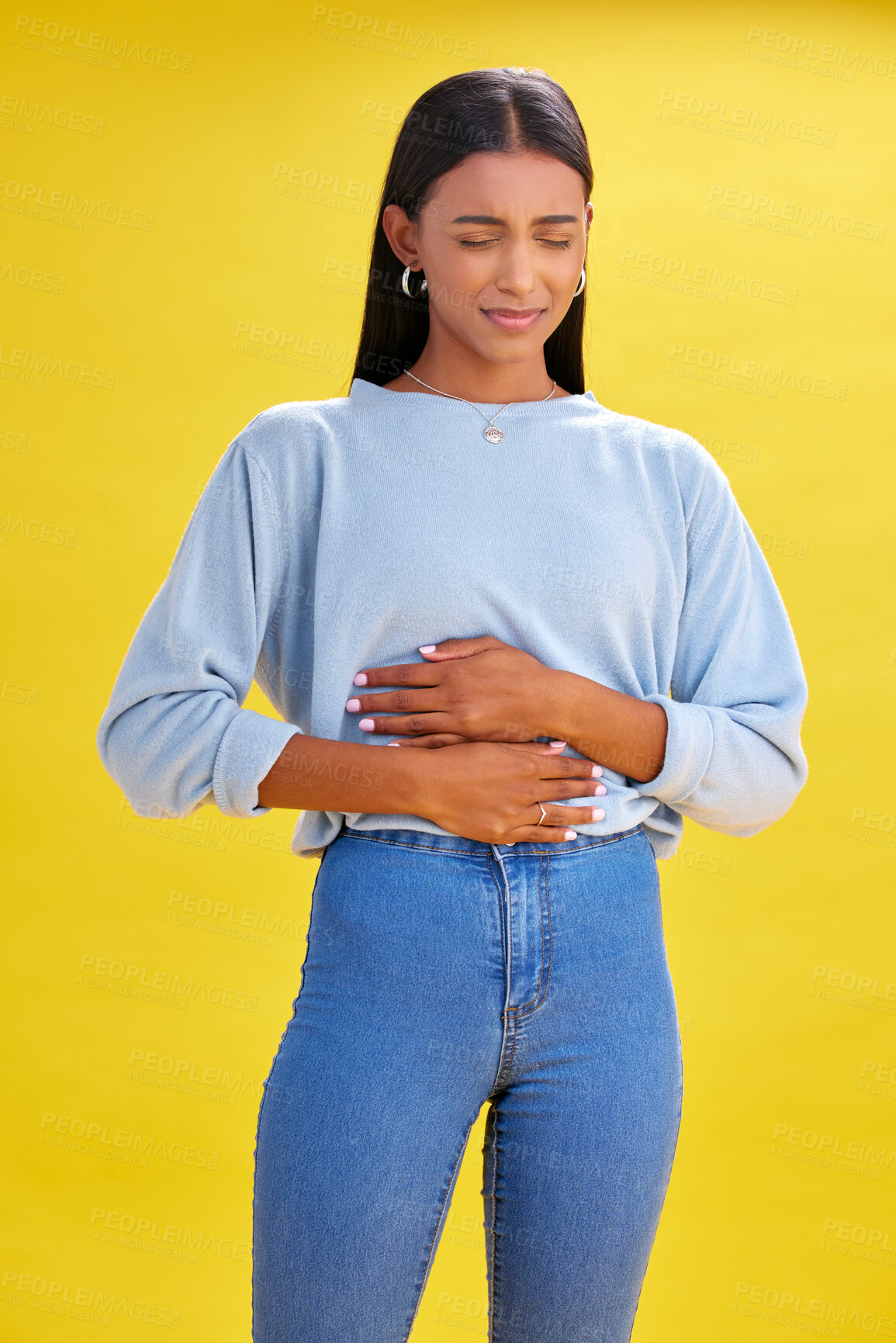 Buy stock photo Sick, stomach pain and woman with constipation, digestion problem or diarrhea in studio isolated on a yellow background. Abdomen gas, disease and person with menstrual cramps, endometriosis or hernia