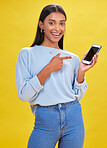 Woman, portrait and phone screen in presentation, advertising space and e learning news or opportunity in studio. Young person or student pointing to mobile app or contact mockup on yellow background
