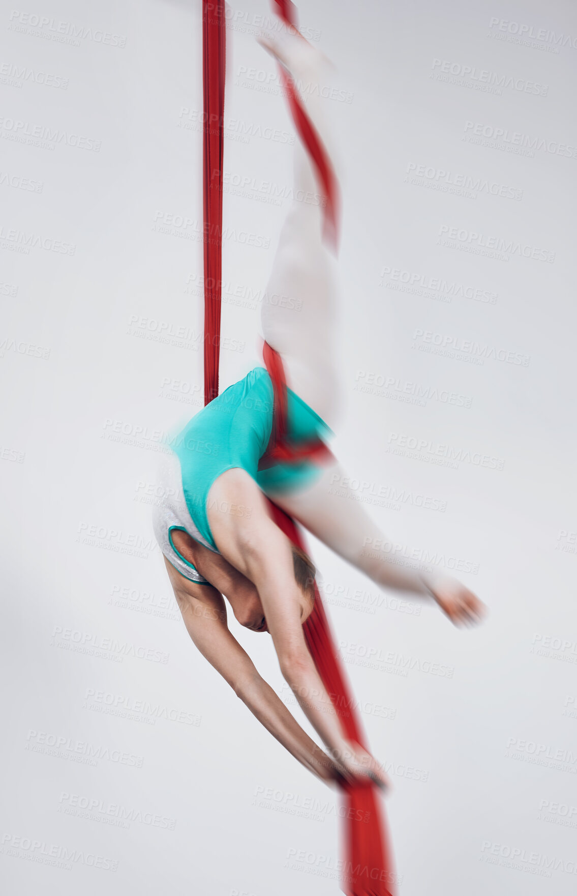 Buy stock photo Sport, acrobat and aerial silk with a woman in air for performance, gymnastics and balance. Young athlete person or gymnast hanging on red fabric and white background with space, art and creativity