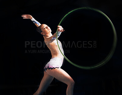 Buy stock photo Portrait, training with a gymnastics hoop and a woman in the gym for a performance showcase or practice. Fitness, dance and concert with a female athlete on a dark background for routine or recital