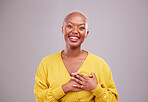 Thank you, smile and portrait of a black woman in a studio with sweet, happy and positive attitude. Empathy, gratitude and young African female model with grateful gesture isolated by gray background