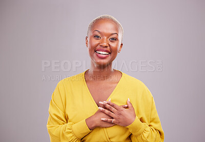 Buy stock photo Thank you, smile and portrait of a black woman in a studio with sweet, happy and positive attitude. Empathy, gratitude and young African female model with grateful gesture isolated by gray background
