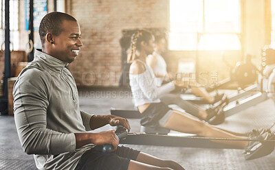 Buy stock photo Exercise, happy man and rowing machine in gym for group class, fitness workout and cardio training. African bodybuilder, athlete and challenge to row on sports equipment for energy, muscle and power