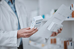 Person, pharmacist and hands with box of medication, pharmaceutical or pills on shelf at drugstore. Closeup of medical or healthcare employee with drugs, prescription meds or inspection at pharmacy