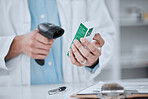 Person, pharmacist and hands scanning box in price check, inventory or inspection on medication at pharmacy. Closeup of medical or healthcare employee checking cost on pharmaceutical product or drug