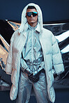 Holographic, vaporwave and man with fashion and futuristic ski style with sci fi clothing in studio. Art, creative and young male model with trendy, cool sunglasses and cyberpunk designer jacket