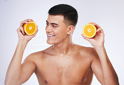 Buy stock photo Beauty, orange and skincare with face of man in studio for health, detox and natural cosmetics. Vitamin c, nutrition and summer with person and fruit on white background for self care and glow 