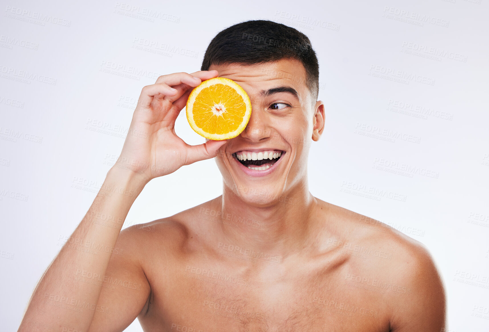 Buy stock photo Beauty, orange and happy with face of man in studio for health, detox and natural cosmetics. Vitamin c, nutrition and summer with face of person and fruit on white background for self care and glow 