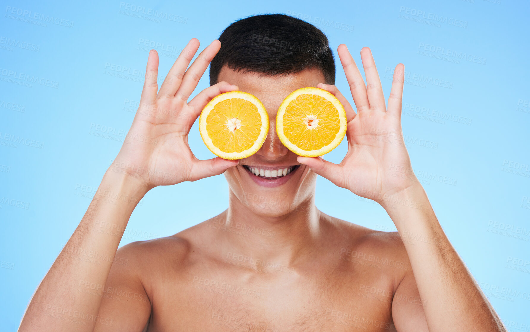 Buy stock photo Happy, lemon and skincare with face of man in studio for health, detox and natural cosmetics. Vitamin c, nutrition and summer with person and fruit on blue background for self care, beauty and glow 