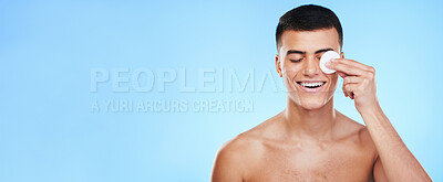 Buy stock photo Cotton pad, skincare and man on blue background for wellness, healthy skin and facial care. Dermatology banner, beauty mockup and person with patch for grooming, cosmetics and face hygiene in studio