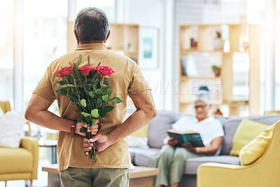 Buy stock photo Love, surprise and senior man with roses behind back for romance, gratitude and commitment to wife in living room of home. Couple, person and flowers in hand for gift and marriage anniversary 