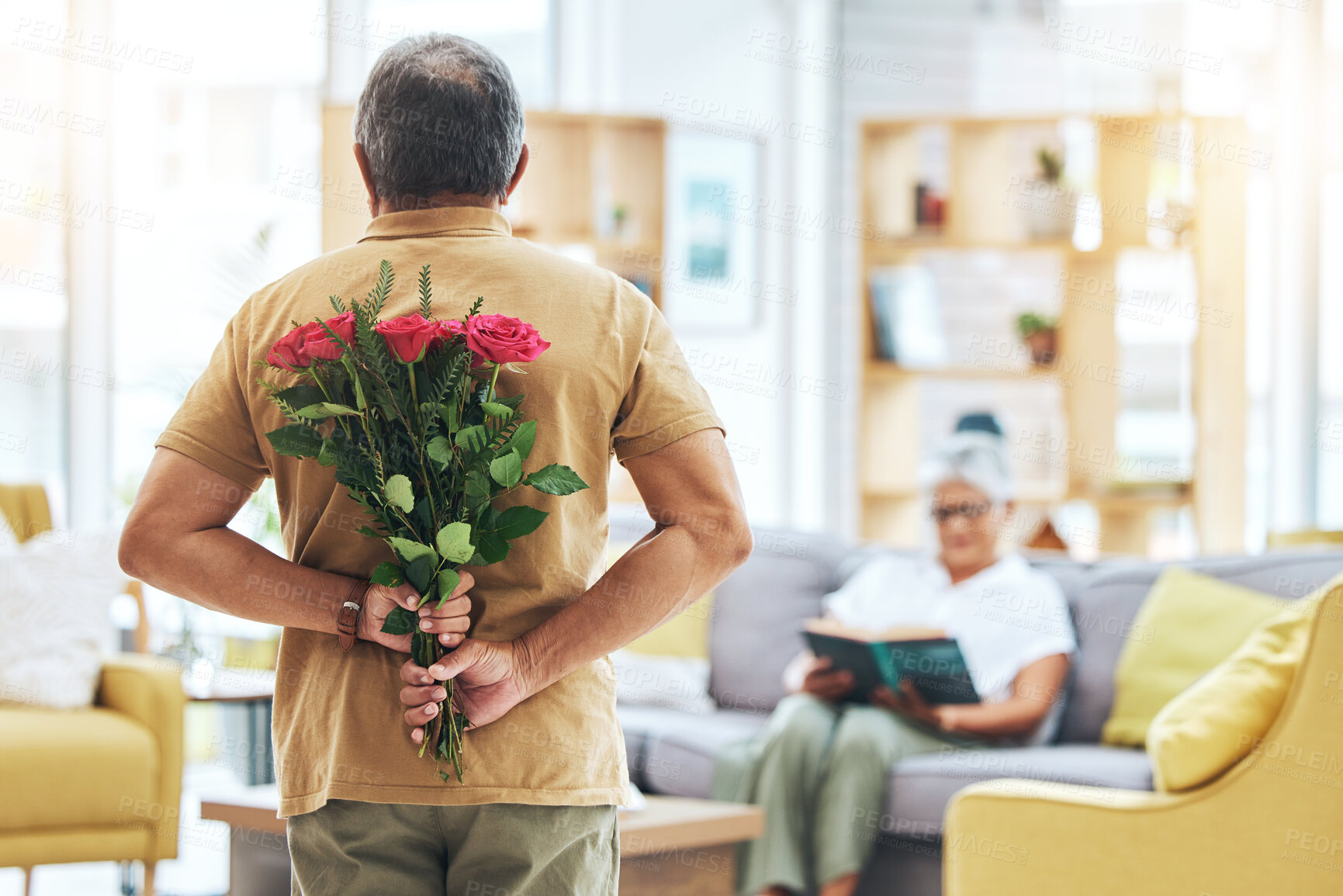 Buy stock photo Love, surprise and senior man with roses behind back for romance, gratitude and commitment to wife in living room of home. Couple, person and flowers in hand for gift and marriage anniversary 