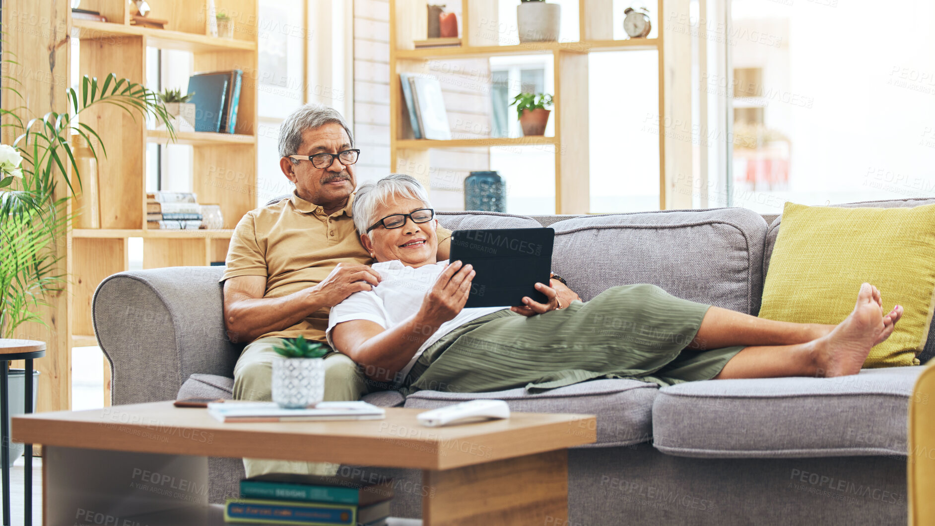 Buy stock photo Relax, senior couple and a tablet for a movie, reading information or streaming a film on the sofa. Smile, house and an elderly man and woman with technology for a show, notification or an email