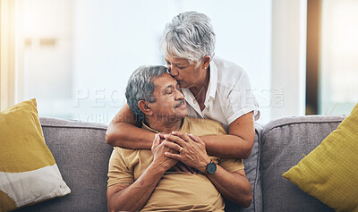 Buy stock photo Love, kiss and senior couple on sofa for bonding, healthy marriage and relationship in living room. Retirement, hug and loving man and woman on couch embrace for trust, commitment and care at home