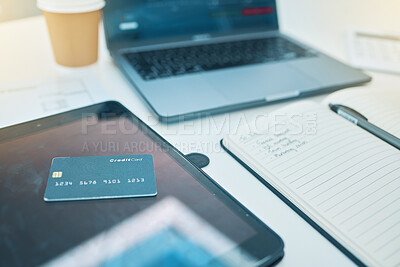 Buy stock photo Desk, technology and a credit card with a notebook for work, planning business or finance. Closeup, ecommerce and notes for a corporate or accounting goal on a table for a payment on a tablet or pc