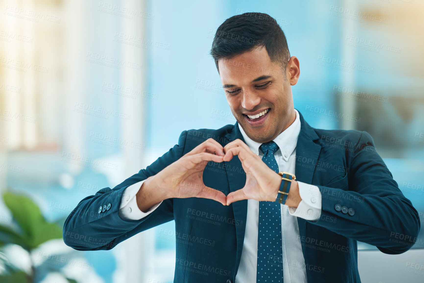 Buy stock photo Hands, heart and happy business man with love, care and kindness of like emoji in office. Corporate employee, smile and finger shape for thank you, trust and sign of hope, support and icon of peace