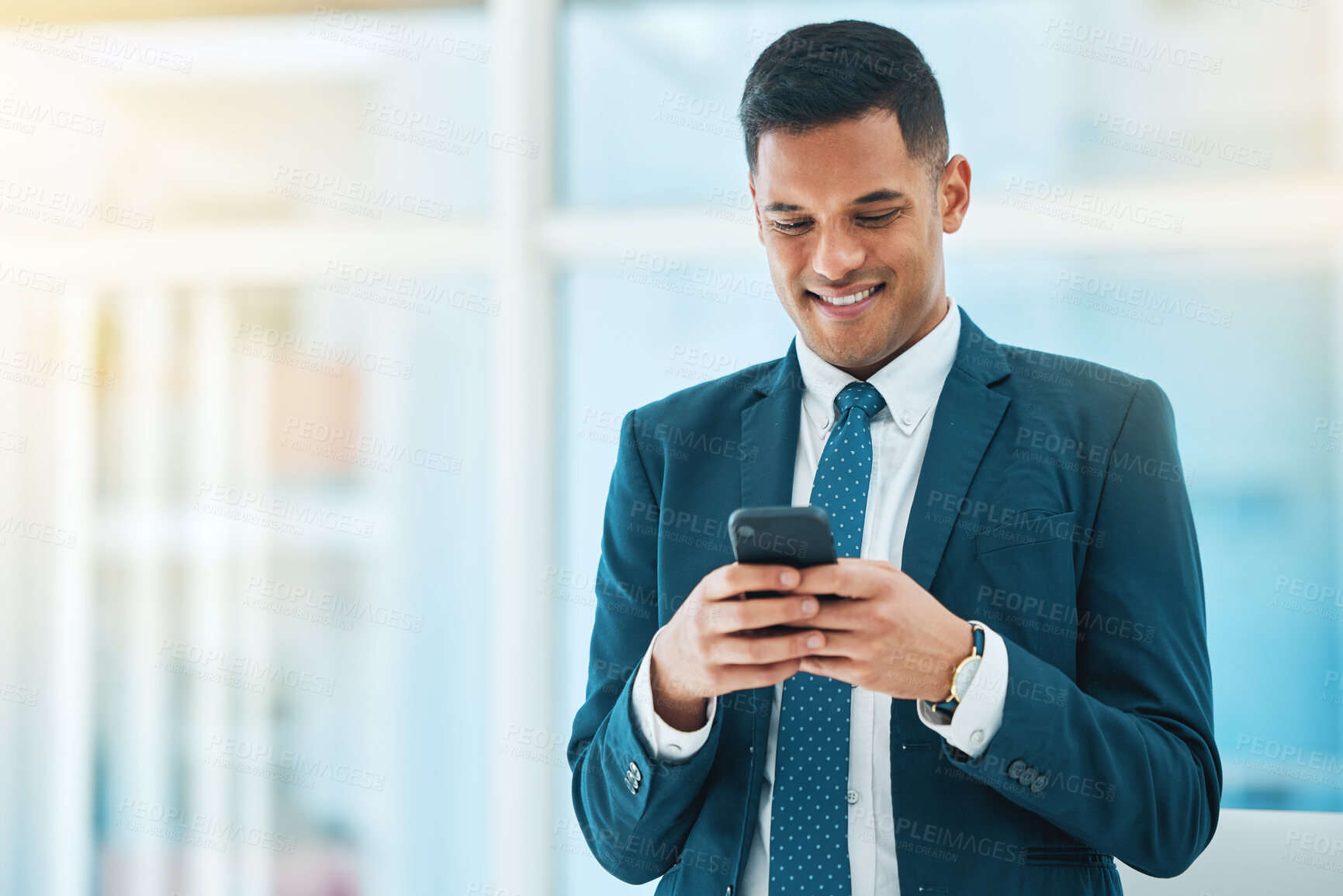 Buy stock photo Phone, smile and mockup with a business man in his office, typing a text message for communication. Mobile, contact and networking with a happy young employee chatting online in a corporate workplace