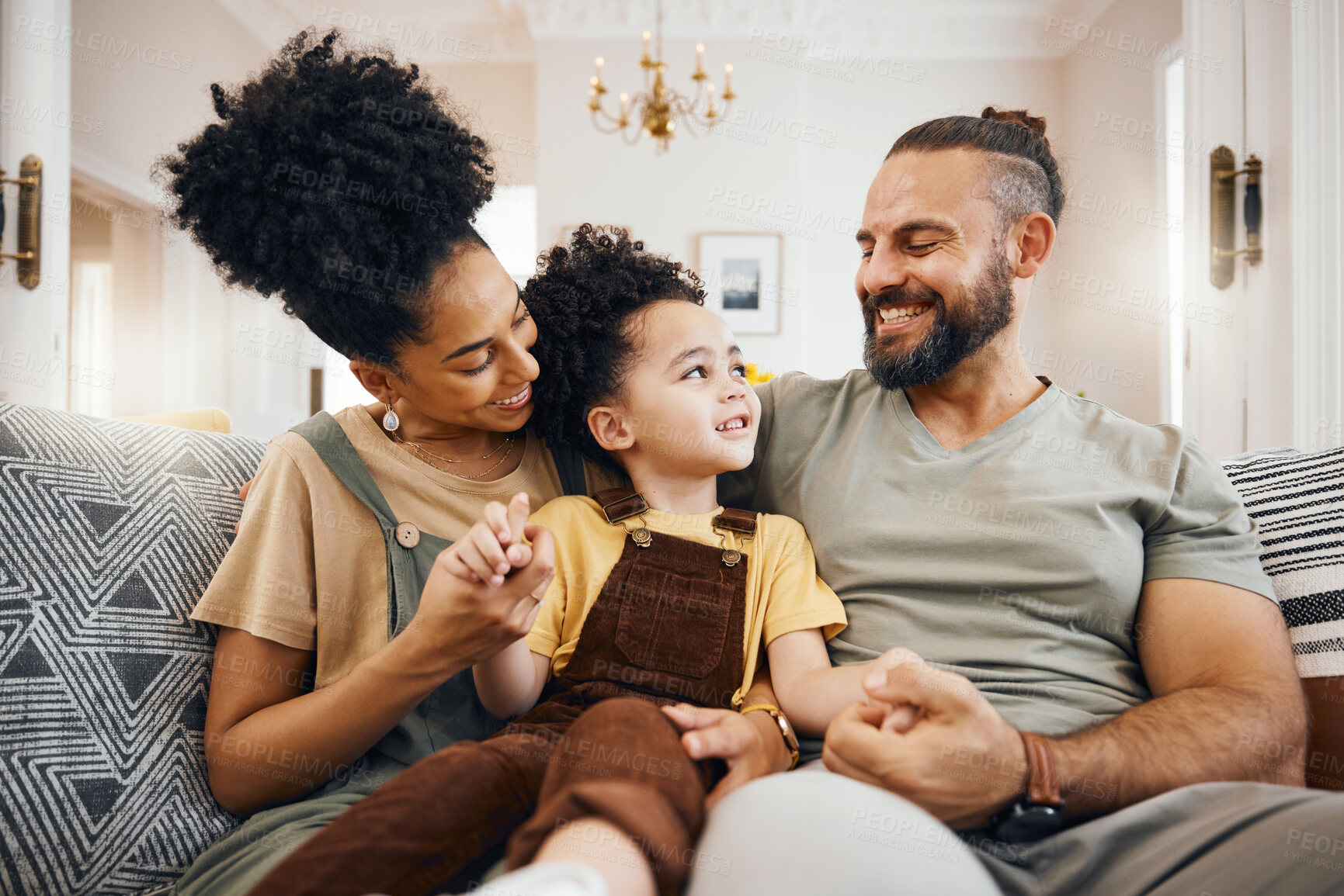 Buy stock photo Smile, bonding and interracial family on the sofa for conversation, love and talking. Happy, house and a mother, father and a boy child on the couch for comfort, care and together for communication