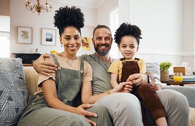 Buy stock photo Interracial parents, kid and portrait on sofa, smile and hug with care, bonding and love in living room. Mother, father and child with embrace, relax and happy together on lounge couch in family home