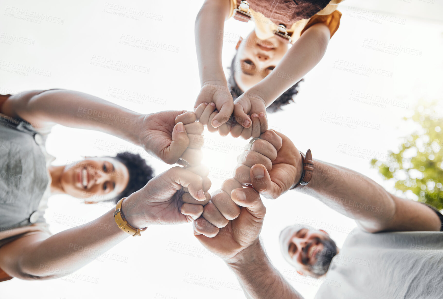 Buy stock photo Family, fist bump and circle outdoor together in low angle, happy and bonding. Father, mother and child hands in huddle to love, solidarity and parents support in cooperation, connection and success