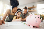 Piggy bank, table and parents with child, learning and writing with headphones, paper and saving advice. Mom, dad and kid for education, investing and helping for future in interracial family house