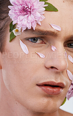 Buy stock photo Plant, skincare and flowers with portrait of man in studio for beauty, natural and creative. Glow, cosmetics and spring with face of model on white background for makeup, spa and floral wellness