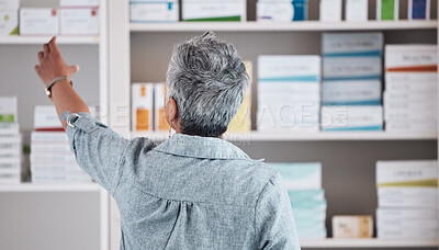 Buy stock photo Patient, pharmacy and pharmaceutical shelf in self medication, healthcare or boxes at the drugstore. Back view of customer reaching for medical product, healthy supplements or antibiotics at clinic
