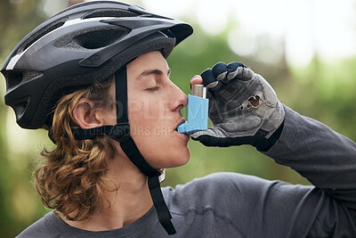 Buy stock photo Asthma, cyclist and man with medical emergency and breathing medicine in a forest for exercise or fitness. Lung, training and young person with support for health, wellness and relief inhaler