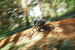 Bicycle, man in forest and speed blur in workout outdoor in woods for healthy body. Mountain bike, nature and athlete training, cycling fast or off road adventure on journey, exercise or sport travel