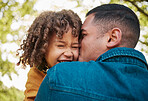 Happy father, child and kiss in care, love or bonding together on outdoor holiday, weekend or break in the park. Dad and kid enjoying family time, embrace or fun and playful childhood in nature