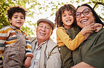Grandparents, children and portrait with a smile in park, garden or happy family relax together outdoor in backyard. Kids, hug grandmother and grandfather in nature on holiday or vacation with love