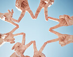 Hands, star and blue sky, support and solidarity with team huddle, community and V sign with connection. Social, goals and mission with group of people outdoor, cooperation and synergy with low angle