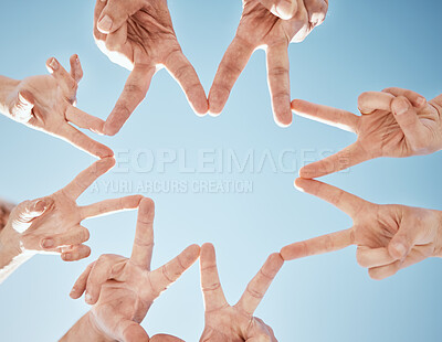 Buy stock photo Hands, star and blue sky, support and solidarity with team huddle, community and V sign with connection. Social, goals and mission with group of people outdoor, cooperation and synergy with low angle
