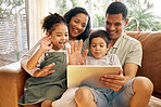 Tablet, video call and family with wave, greeting and smile on a living room sofa at home. Mother, dad and children together with online communication of parents and kids with discussion on web app