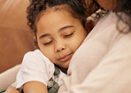 Family, love and face of a girl with her mother closeup in the living room of their home together for support. Care, hug and daughter sleeping in the arms of a parent on a sofa for trust or security