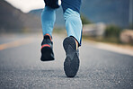 Street, legs and fitness person running for outdoor exercise, cardio workout or training for marathon race on asphalt road. Sports shoes, athlete foot steps or feet of closeup runner doing challenge