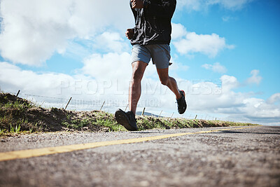 Buy stock photo Legs, fitness and running with a man on a road on a blue sky and clouds for cardio training in a race. Exercise, health and challenge with a male runner or athlete outdoor for a workout or marathon
