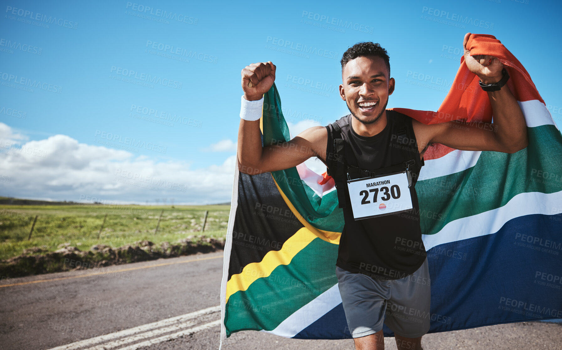 Buy stock photo Portrait, sports and flag of South Africa with a man running on a street in nature for motivation or success. Fitness, winner or celebration with a runner cheering during cardio or endurance training