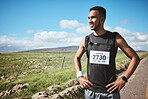 Fitness, smile and man runner in the countryside for competition, running or workout in nature. Sports, race and happy male athlete in a road for training, exercise or break for performance challenge