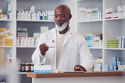 Buy stock photo Black man, pharmacist and pill box with a tablet, medication boxes and healthcare with inventory. Person, pharmacy and professional with information, drugstore and medicine with tech and prescription