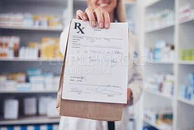 Buy stock photo Woman, pharmacist and hand with paper bag for prescription, note or doctor certificate at pharmacy. Closeup of female person or medical professional giving medication or pharmaceutical at drugstore